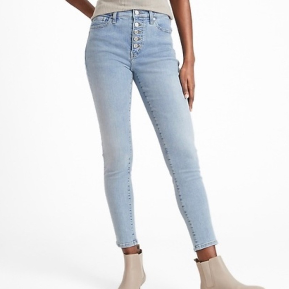 Light wash high rise skinny jeans with button fly.